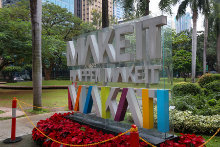MANILA, PHILIPPINES - DECEMBER 7, 2017: Make It Happen, Make It Makati sign at Ayala Triangle, Makati, Metro Manila. Metro Manila is one of the biggest urban areas in the world with 24 million people.のeditorial素材