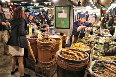 KYOTO, JAPAN - NOVEMBER 27, 2016: People shop at Nishiki Market in Kyoto, Japan. Nishiki is a popular traditional food market in Kyoto.のeditorial素材