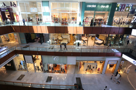 DUBAI, UAE - NOVEMBER 22, 2017: Shoppers visit the Human Waterfall art piece at Dubai Mall. It is the largest mall in the world by total area with 502,000 square metres retail area.のeditorial素材