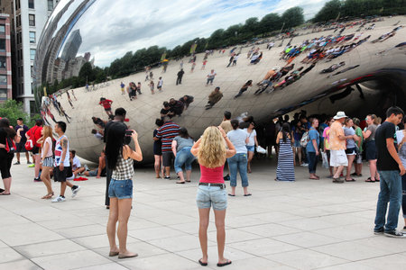 CHICAGO, USA - JUNE 28, 2013: People visit Cloud Gate (a.k.a. The Bean) in Millennium Park in Chicago. With 2.7 million residents, Chicago is the 3rd most populous city in the USA.のeditorial素材