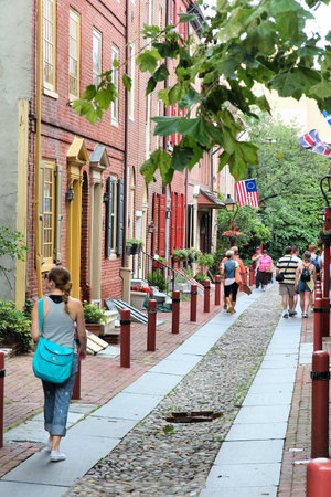 PHILADELPHIA, USA - JUNE 11, 2013: People visit Elfreth's Alley in Philadelphia. The alley is a National Historic Landmark. It dates back to 1702.のeditorial素材