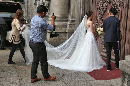 MANILA, PHILIPPINES - NOVEMBER 25, 2017: Wedding photographer takes photos of the bride in Manila, Philippines. It is typical to spend big on weddings in Philippines.のeditorial素材