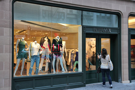 NEW YORK, USA - JULY 1, 2013: Person visits Intermix fashion store in 5th Avenue, New York. 5th Avenue is ranked the most expensive retail area (per square foot) in the world.のeditorial素材