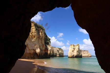 Portugal Atlantic coast landscape in Algarve region. Praia do Pinhao sandy beach. Hidden cove.