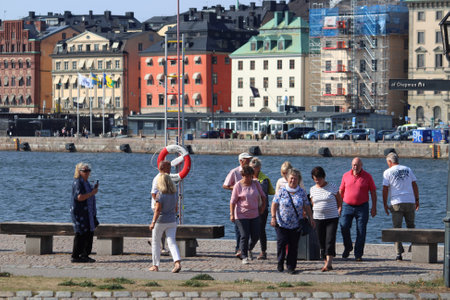 STOCKHOLM, SWEDEN - AUGUST 24, 2018: Tourists visit waterfront in Skeppsholmen island, Stockholm, Sweden. Stockholm is the capital city and most populous area in Sweden.のeditorial素材