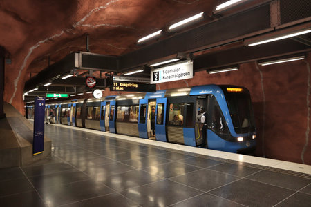 STOCKHOLM, SWEDEN - AUGUST 24, 2018: People ride Stockholm metro (T-bana) in Sweden. Stockholm metro is known for its artistic station interiors.のeditorial素材