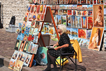 KRAKOW, POLAND - AUGUST 28, 2018: Artist sells paintings at St. Florian's Gate, Krakow. The Historic Centre of Krakow is a UNESCO World Heritage Site.のeditorial素材