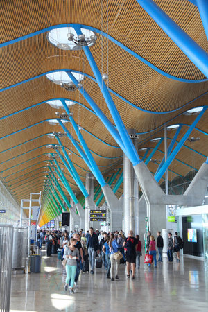 MADRID, SPAIN - OCTOBER 5, 2014: Passengers visit Terminal 4 of Madrid Barajas Airport. The famous Terminal 4 was designed by Antonio Lamela and Richard Rogers.のeditorial素材