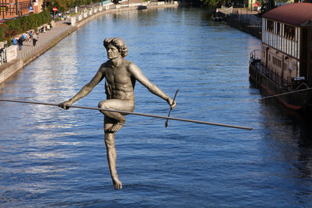 BYDGOSZCZ, POLAND - SEPTEMBER 4, 2010: Statue "Crossing the River" in Bydgoszcz. Artwork authored by Jerzy Kedziora is a known landmark since 2004.のeditorial素材