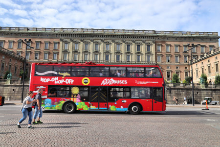 STOCKHOLM, SWEDEN - AUGUST 24, 2018: People ride a hop-on hop-off bus tour in Stockholm city. Stockholm is the capital city and most populous area in Sweden.のeditorial素材