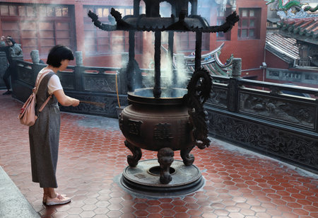 LUKANG, TAIWAN - DECEMBER 2, 2018: Person visits incense burner at Mazu Temple in Lukang, Taiwan. Lukang city boasts over 200 temples.のeditorial素材