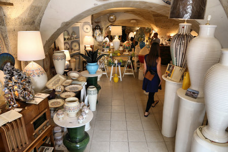 GROTTAGLIE, ITALY - JUNE 3, 2017: People visit a traditional ceramics handicraft shop in Grottaglie, Italy. Grottaglie is a famous handmade ceramics production town in the region of Apulia.のeditorial素材