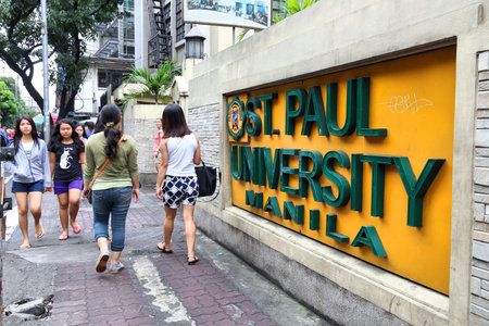 MANILA, PHILIPPINES - NOVEMBER 24, 2017: People walk by St. Paul University in Manila, Philippines....