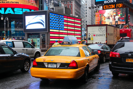 NEW YORK, USA - JUNE 10, 2013: Yellow cabs drive in rain in Times Square, New York City. Times Square has over 39 million annual visitors. It is an important landmark of Midtown Manhattan.のeditorial素材