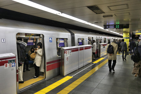 TOKYO, JAPAN - NOVEMBER 30, 2016: People wait for Toei Subway in Tokyo. Toei Subway and Tokyo Metro have 285 stations and have 8.7 million daily users.のeditorial素材