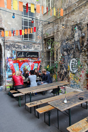 BERLIN, GERMANY - AUGUST 27, 2014: People visit old Hackesche Hofe in Berlin. The art nouveau architecture complex dates back to 1906 and part of it is covered in notable urban art.のeditorial素材