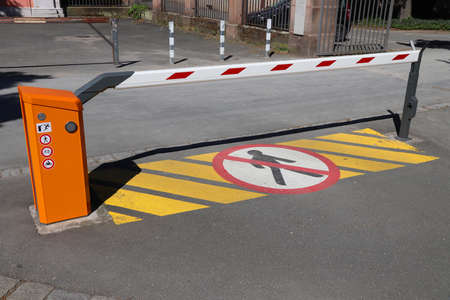 Car parking entrance automatic barrier. Generic red white gate barrier.の写真素材