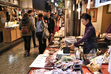 KYOTO, JAPAN - NOVEMBER 27, 2016: People shop at Nishiki Market in Kyoto, Japan. Nishiki is a popular traditional food market in Kyoto.のeditorial素材