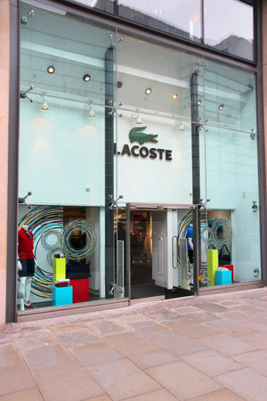 MANCHESTER, UK - APRIL 22, 2013: Lacoste fashion store in Manchester, UK. Lacoste is present in 112 countries. It exists since 1933 and has 1,000 stores.のeditorial素材