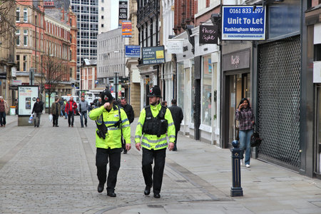 MANCHESTER, UK - APRIL 22, 2013: Police officers patrol streets of Manchester, UK.のeditorial素材