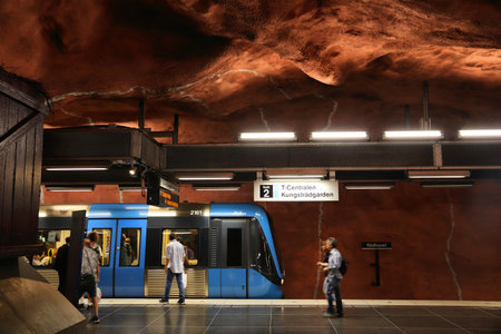 STOCKHOLM, SWEDEN - AUGUST 24, 2018: People ride Stockholm metro (T-bana) in Sweden. Stockholm metro is known for its artistic station interiors.のeditorial素材