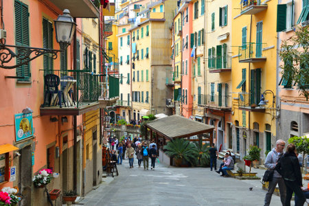 RIOMAGGIORE, ITALY - APRIL 26, 2015: People visit Riomaggiore in Italy. It is part of Cinque Terre, a UNESCO World Heritage site established in 1997.のeditorial素材