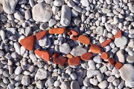 Christian religion fish symbol made of beach pebbles. Ichthys symbol.の写真素材
