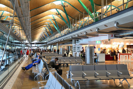 MADRID, SPAIN - NOVEMBER 20, 2016: People wait at Terminal T4 Madrid Barajas Airport in Spain. It is the 6th busiest airport in Europe, with 50.4 million passengers in 2016. It is managed by AENA.のeditorial素材