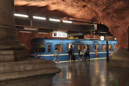 STOCKHOLM, SWEDEN - AUGUST 24, 2018: People ride Stockholm metro (T-bana) in Sweden. Stockholm metro is known for its artistic station interiors.のeditorial素材