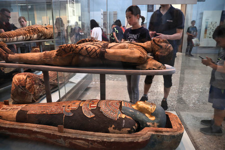 LONDON, UK - JULY 14, 2019: Tourists visit Egyptian mummies in British Museum, London. The museum...