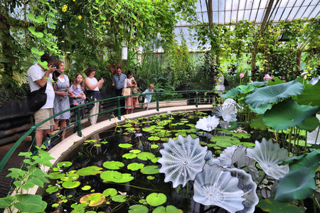 KEW, UK - JULY 15, 2019: People visit Waterlily House of Kew Gardens in Greater London. Royal Botanic Gardens are designated as UNESCO World Heritage Site.のeditorial素材