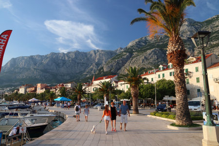 MAKARSKA, CROATIA - JUNE 21, 2019: People visit the harbor promenade in Makarska, Croatia. Croatia had 18.4 million tourist visitors in 2018.のeditorial素材