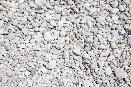 White zen stone beach in Croatia. Pebble background.