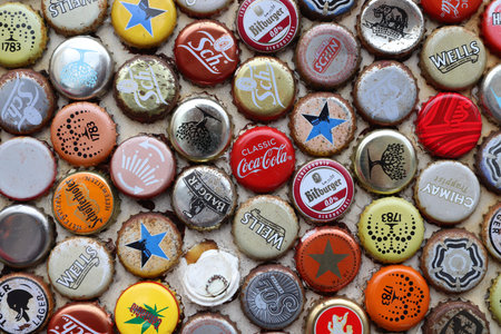 LONDON, UK - JULY 13, 2019: Mixed beer and non alcoholic beverages metal bottle caps in London UK.