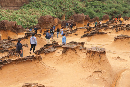 YEHLIU, TAIWAN - NOVEMBER 24, 2018: People visit Yehliu Geopark in Taiwan. Yehliu is a popular tourism destination with peculiar natural rock formsのeditorial素材