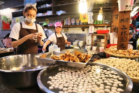 JIUFEN, TAIWAN - NOVEMBER 23, 2018: Cooks prepare traditional food at heritage Old Street market of Jiufen located in Ruifang District of New Taipei City. Jiufen is also known as Jioufen or Chiufen.のeditorial素材