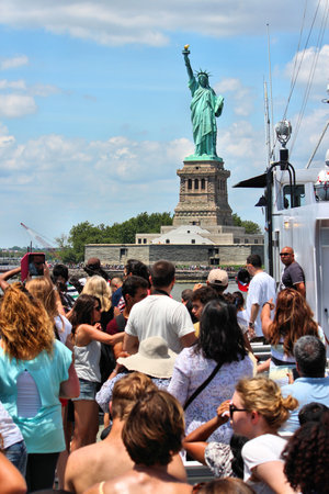 NEW YORK, USA - JULY 6, 2013: Tourists take photos of Statue of Liberty from the ferry boat in New York City, United States.のeditorial素材
