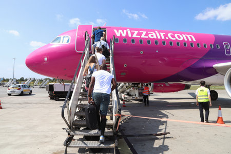 KATOWICE, POLAND - AUGUST 22, 2018: Passengers board low cost airline Wizz Air Airbus A320 aircraft at Katowice Airport in Poland. Katowice is the 4th busiest airport in Poland (4.8 m annual passengers).のeditorial素材