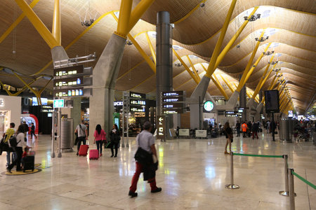 MADRID, SPAIN - DECEMBER 6, 2016: People wait at Terminal T4 Madrid Barajas Airport in Spain. It is the 6th busiest airport in Europe, with 50.4 million passengers in 2016. It is managed by AENA.のeditorial素材
