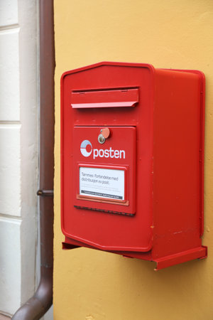 ALESUND, NORWAY - JULY 27, 2020: Red post box of Posten Norge (The Norwegian Post) in Alesund....