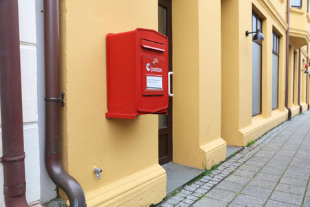 ALESUND, NORWAY - JULY 27, 2020: Red post box of Posten Norge (The Norwegian Post) in Alesund. Posten was founded in 1647.のeditorial素材