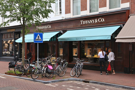 AMSTERDAM, NETHERLANDS - JULY 10, 2017: People visit Tiffany & Co fashion shop at PC Hooftstraat in Amsterdam. Pieter Cornelis Hooftstraat is the ultimate upscale shopping street in the Netherlands.のeditorial素材