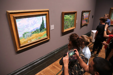 LONDON, UK - JULY 12, 2019: Tourists admire Van Gogh paintings in National Gallery in London. It is the 3rd most visited museum in the UK with 5.7 million annual visitors.のeditorial素材