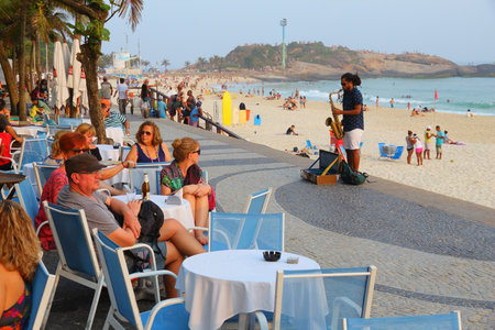 RIO DE JANEIRO, BRAZIL - OCTOBER 18, 2014: People visit Ipanema beachfront walk in Rio de Janeiro. In 2013 1.6 million international tourists visited Rio.のeditorial素材