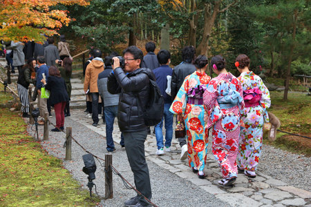 KYOTO, JAPAN - NOVEMBER 26, 2016: Women visit Kodaiji temple gardens in kimono costumes in Kyoto, Japan. 19.7 million foreign tourists visited Japan in 2015.のeditorial素材