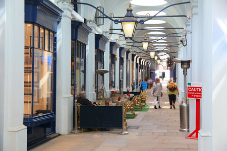 LONDON, UK - JULY 7, 2016: People shop at Royal Opera Arcade in London. The prestigious Royal Opera Arcade Gallery opened in 1818.のeditorial素材