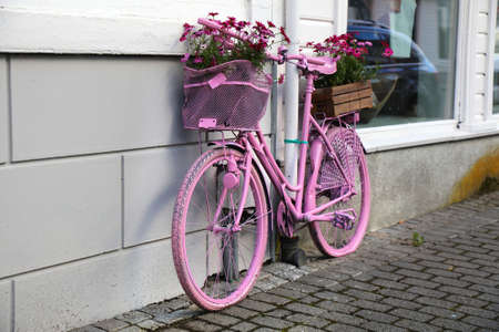 Flekkefjord town in Vest-Agder county of Norway. Street view pink bicycle as a flower stand.の写真素材