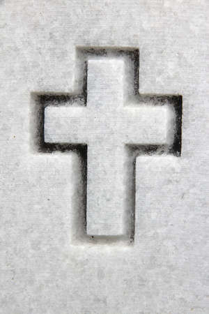 Marble cross engraving. Cemetery Christianity symbol - cross engraved in white stone.の写真素材