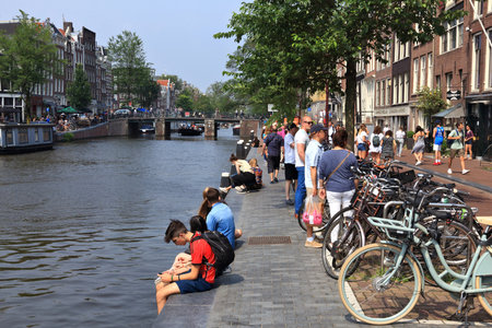AMSTERDAM, NETHERLANDS - JULY 7, 2017: People visit Prinsengracht canal in Amsterdam, Netherlands. Amsterdam is the capital city of The Netherlands.のeditorial素材