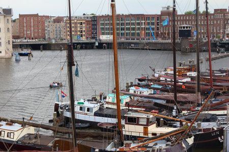 AMSTERDAM, NETHERLANDS - JULY 8, 2017: People visit the Museum Harbor (Museumhaven) in Amsterdam, Netherlands. Moored at the Oosterdok are some historical ships.のeditorial素材